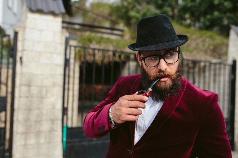 Close up of a man posing with pipe at a cigar shop in Tulsa