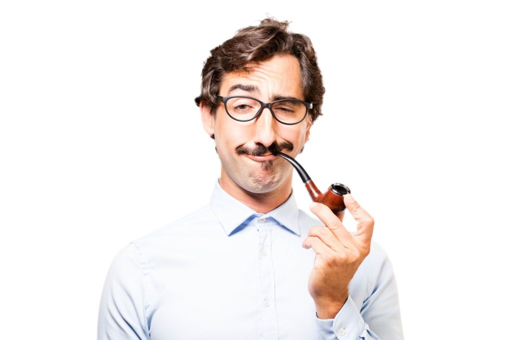 A photo of a man in an eyeglasses doing a funny while smoking glass pipes in Tulsa