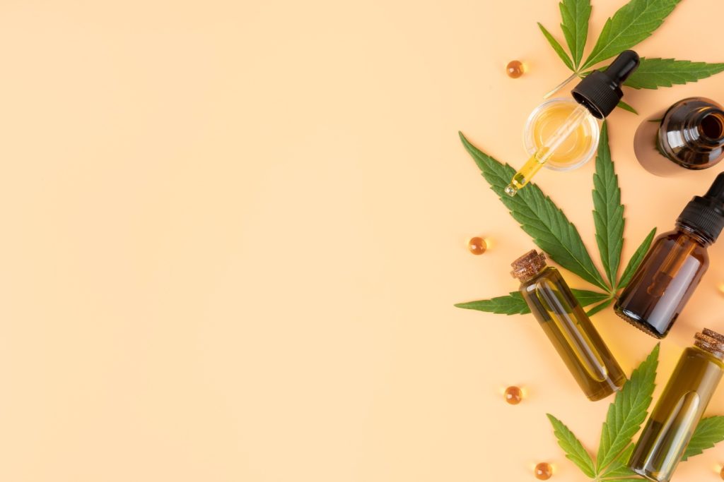 Various CBD oil bottles and cannabis leaves displayed at a cigar shop Tulsa.