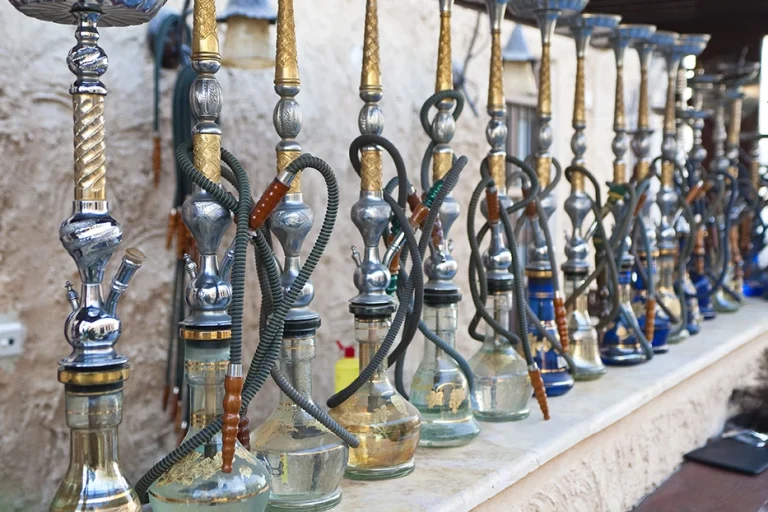 Row of elegant hookahs displayed at a stylish hookah shop in Tulsa, offering a variety of options.