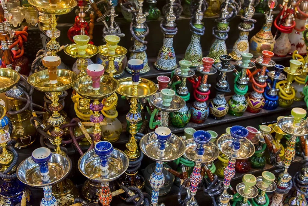Colorful array of ornate hookahs showcased at a vibrant hookah shop in Tulsa for enthusiasts.