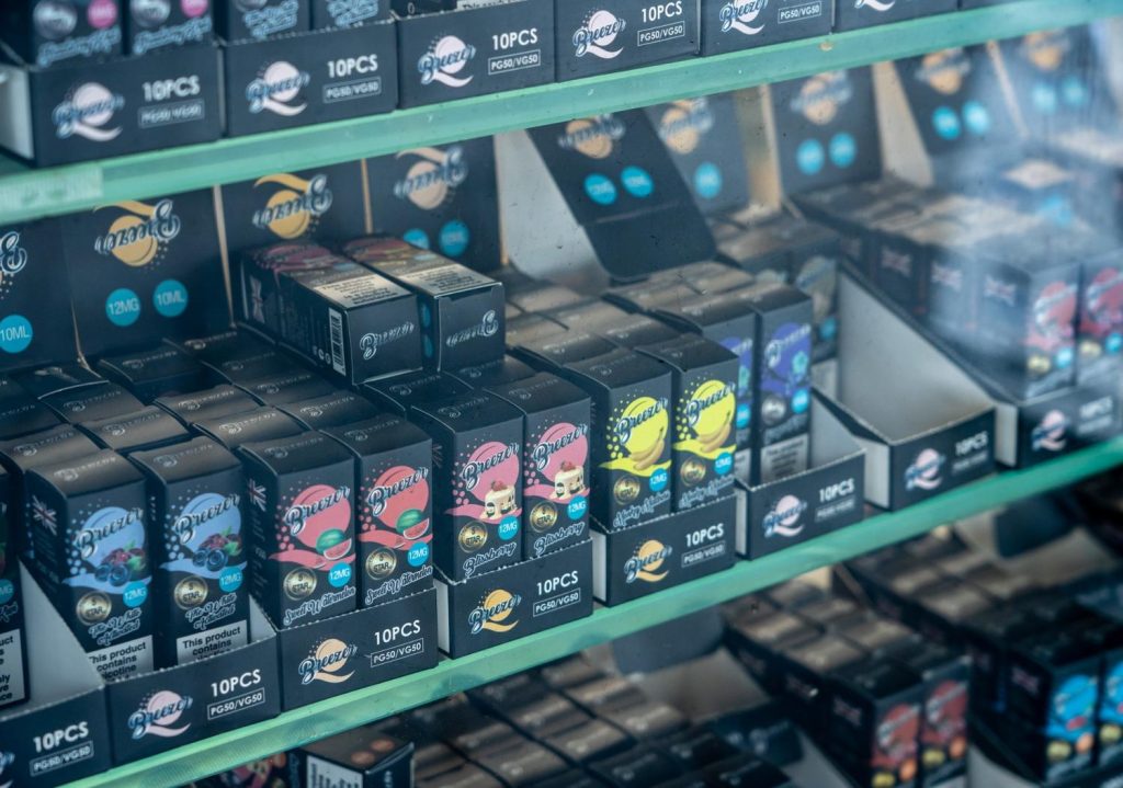 Rows of Breeze disposable vape packs in various fruity flavors like watermelon and banana on display at a well-organized smoke shop Tulsa, ideal for on-the-go users.