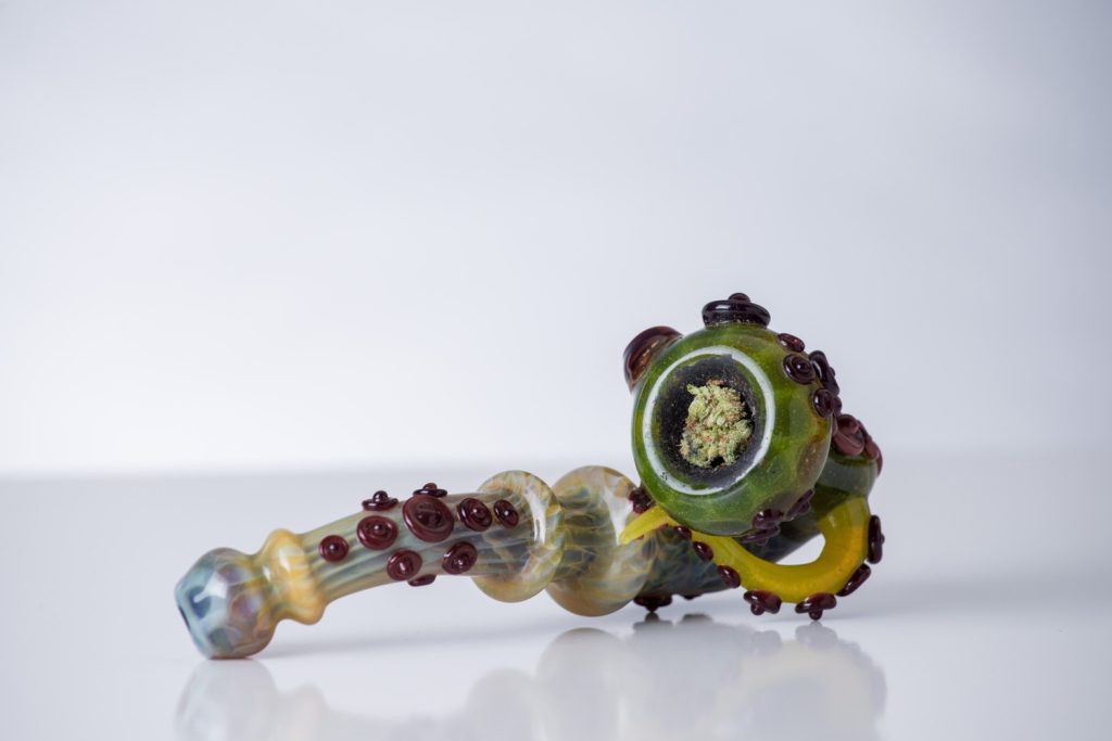 Artistic glass pipe with octopus-inspired accents and cannabis bowl, crafted by a local Glass Pipes Tulsa designer.