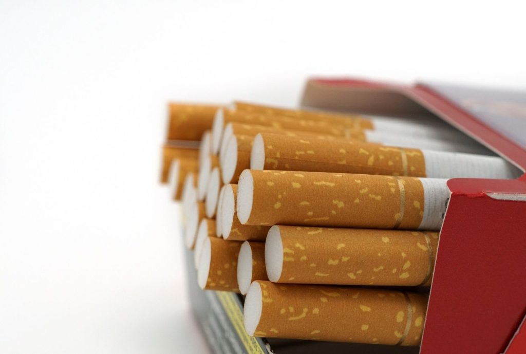 Stack of cigarettes in a red box, available at the best cigarette shop tulsa locations for tobacco products.
