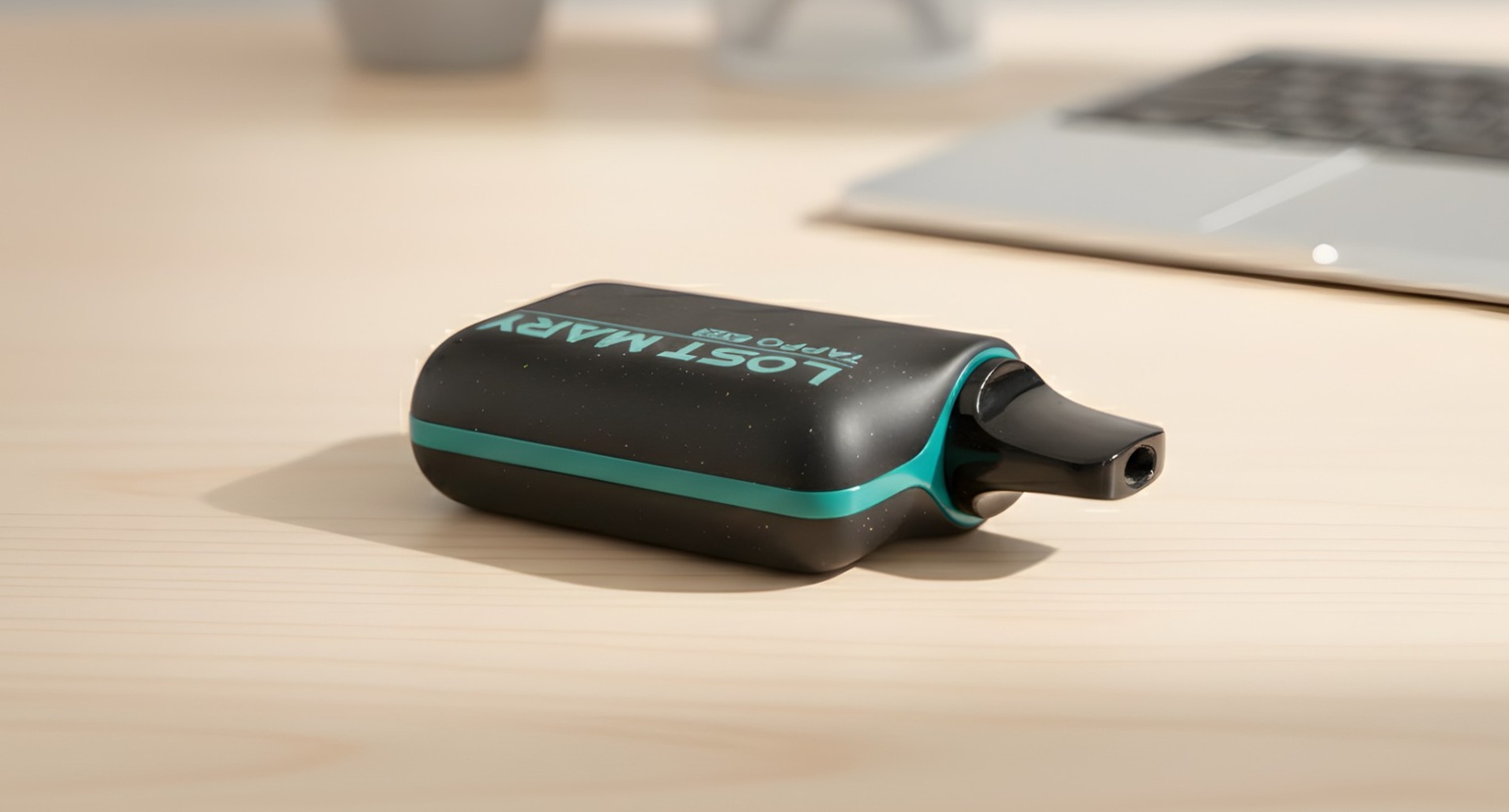 Sleek black Lost Mary Tappo pod kit on a desk, available at our vape shop Tulsa for eco-friendly vaping enthusiasts.