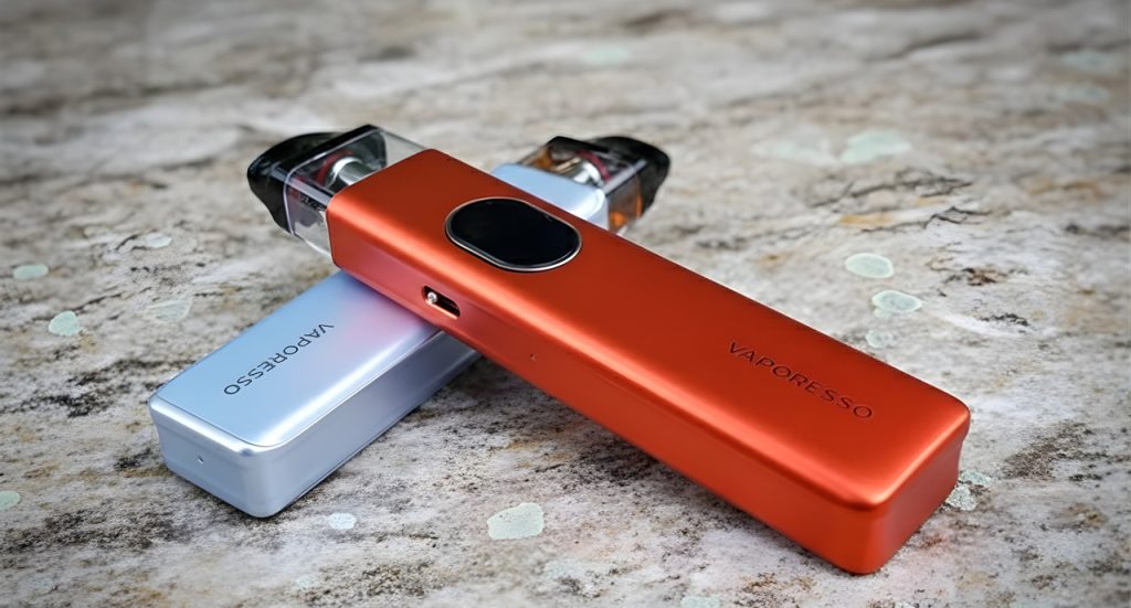 Close-up of orange and silver Vaporesso vape pens on stone, sold at the premier vape shop Tulsa for local vapers.