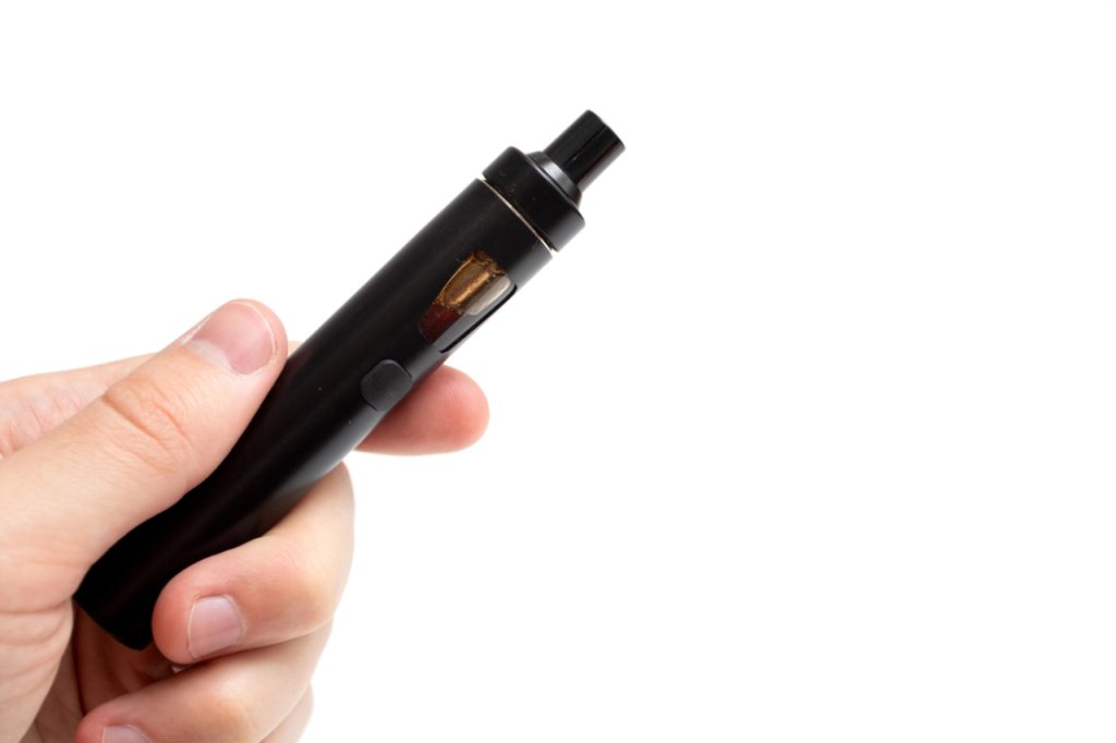 Close up of a sleek black handheld vaporizer available at local stores featuring the best vape mods Tulsa stocks.