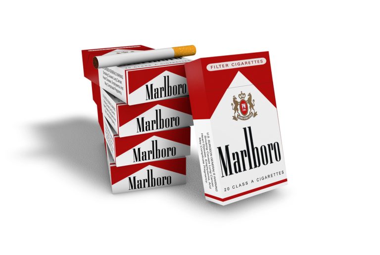 A clean product photo of a stack of Marlboro cigarette packs and a lit cigarette from a cigarette shop tulsa inventory.