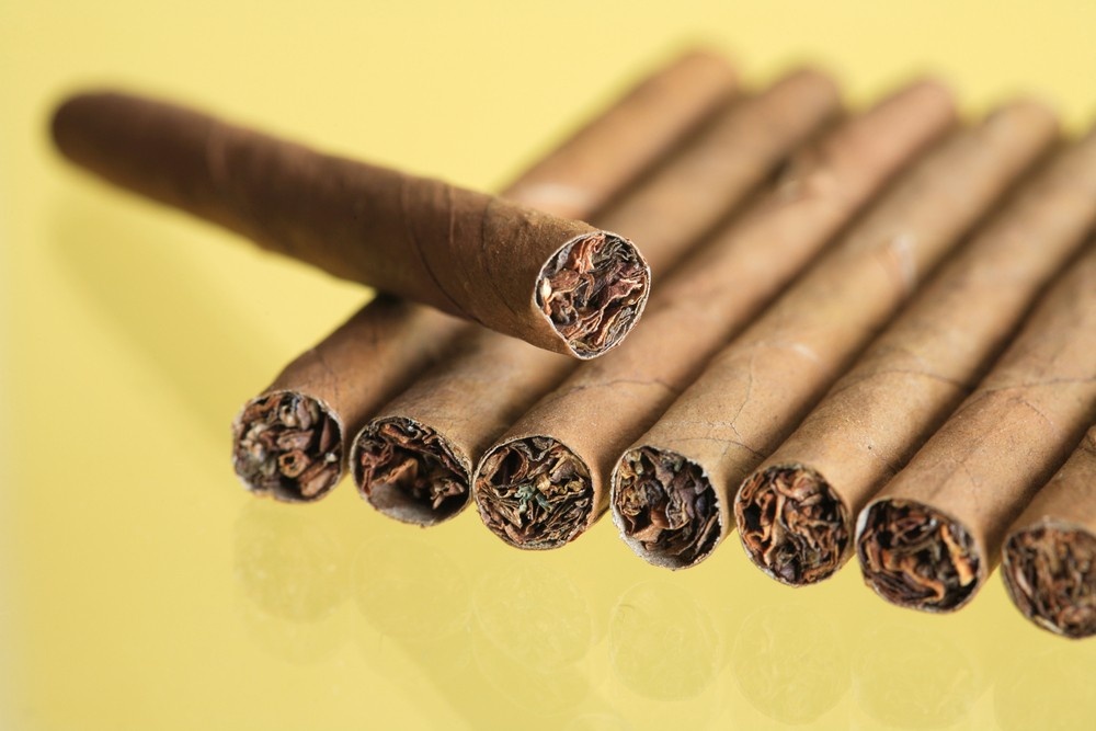 A row of premium cigars at your local tobacco shop tulsa. See the rich tobacco leaf filling and hand-rolled wraps.