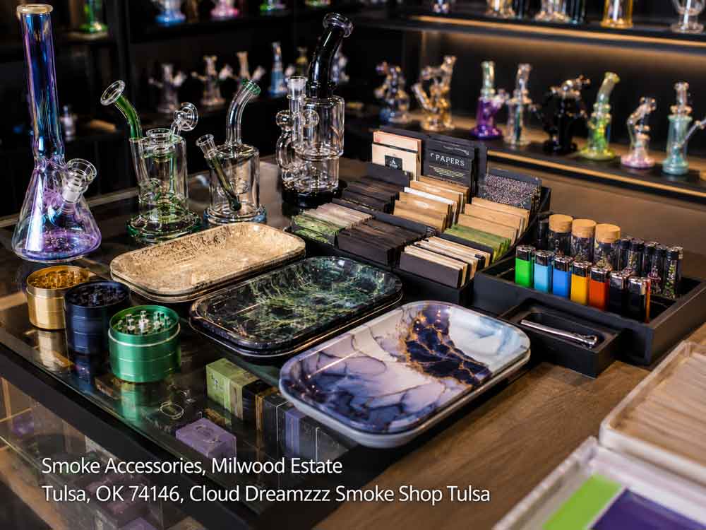 A display counter featuring quality smoke accessories in Tulsa, including colorful rolling trays, papers, and grinders.